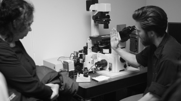 Doctoral candidate Christopher Salmon explains his work to fine arts student Nathalie Dubois-Calero. Photo: Kevin Jung-Hoo Park